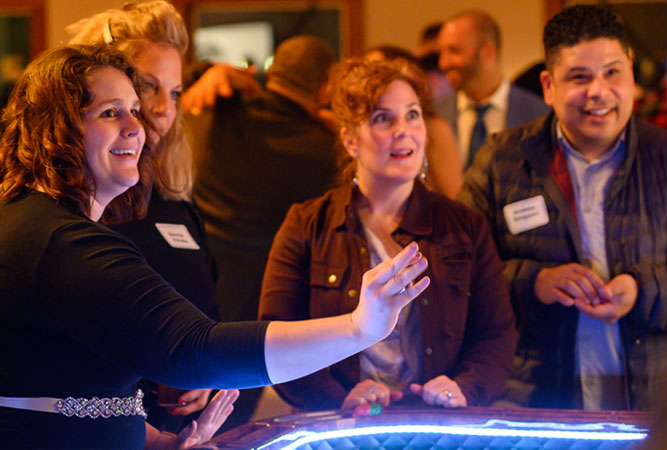 three women playing casino games at event