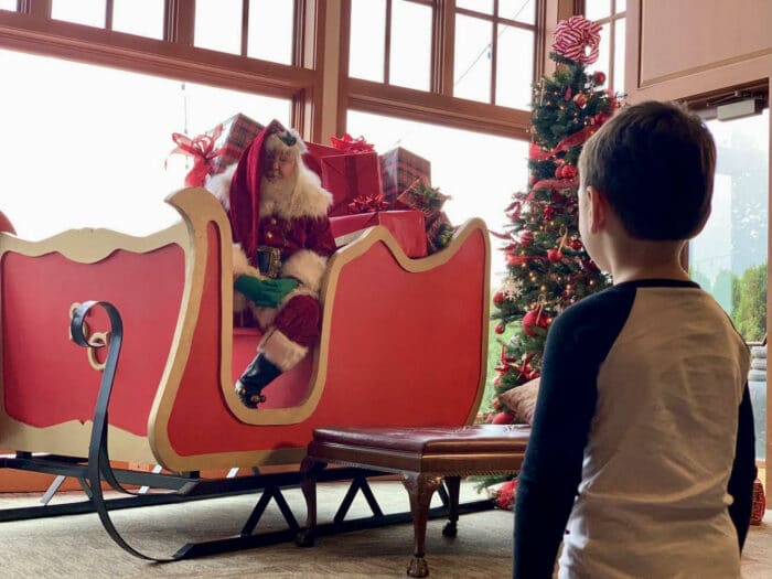 Child meeting Santa in a sleigh