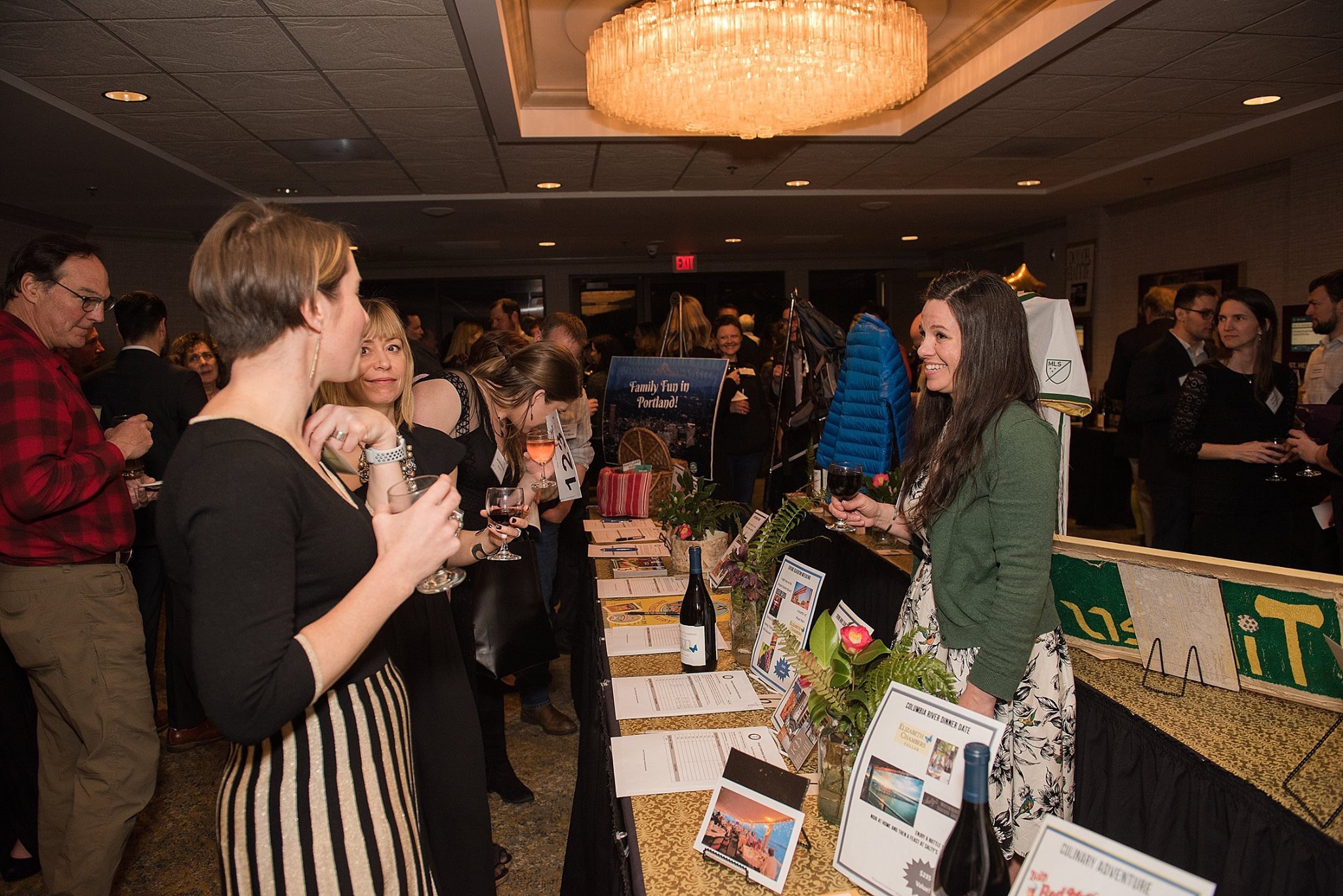 women discusses wine options at event