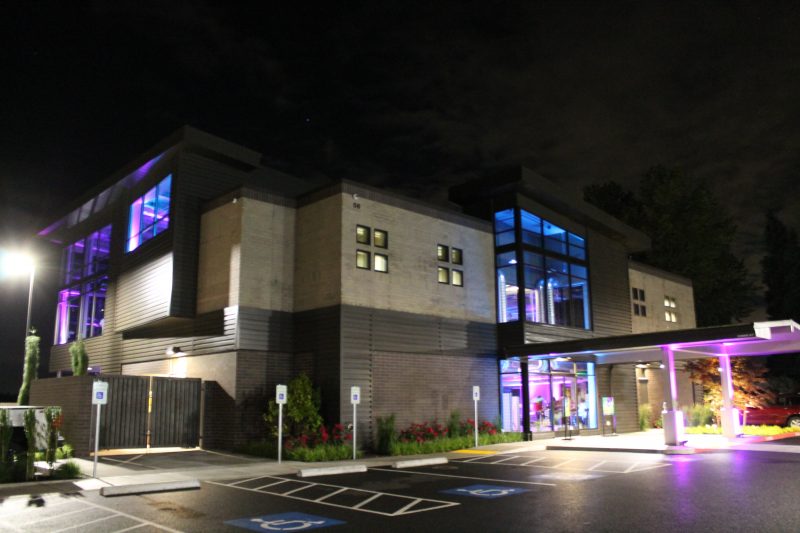 large building with purple entrance lights