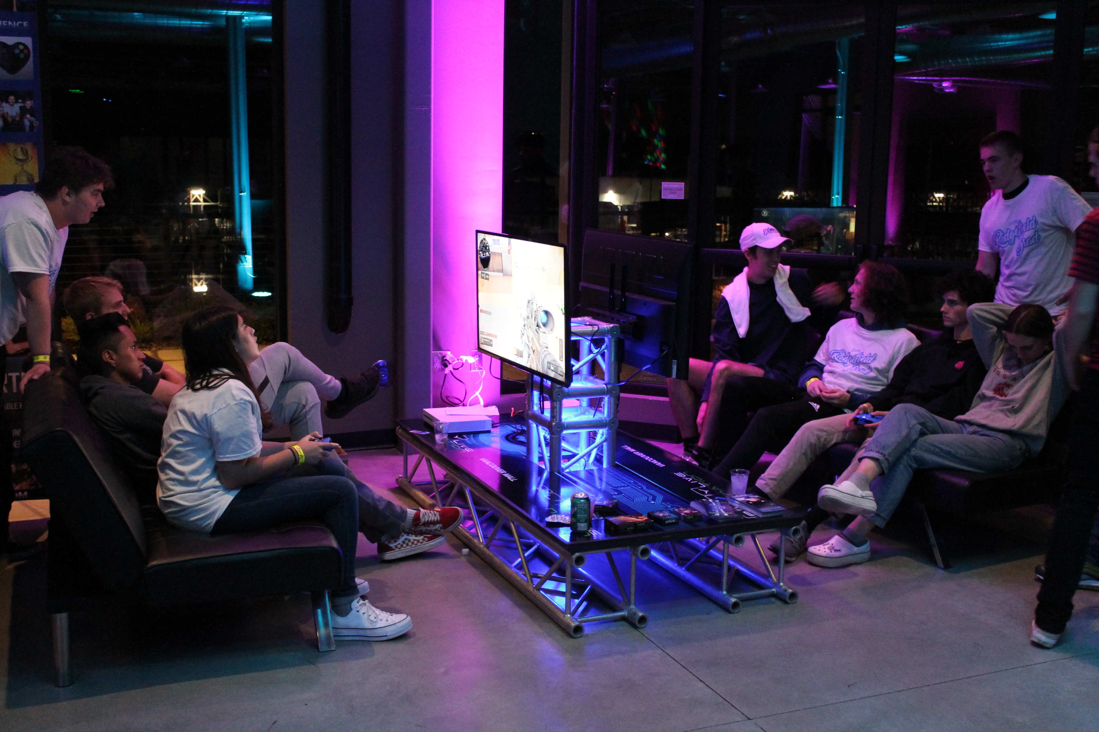 Group of young people playing video games at event