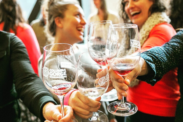 Group shot of guests doing cheers with their wine glasses