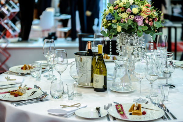 Table setting with colorful floral centerpiece & champagne buckets