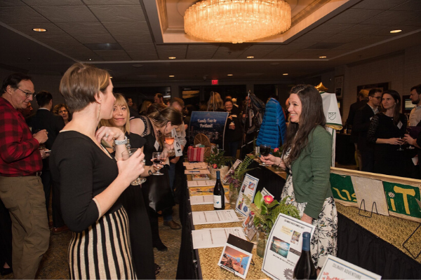 Event guests mingling with vendor booths