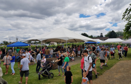 outdoor event with large crowd of families