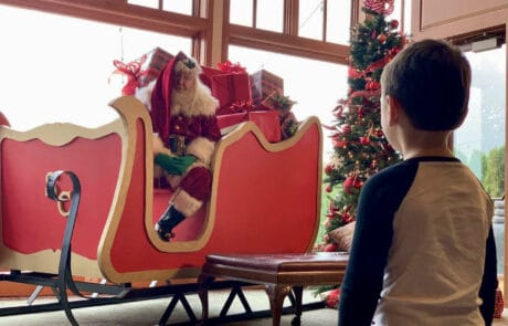 Child meeting santa in his sleigh