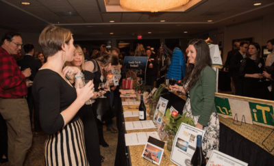 Guests checking out vendor tables at a non-profit event